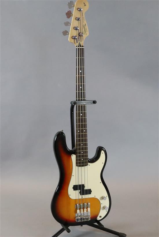 A Squire Fender Precision bass guitar, sunburst with soft case